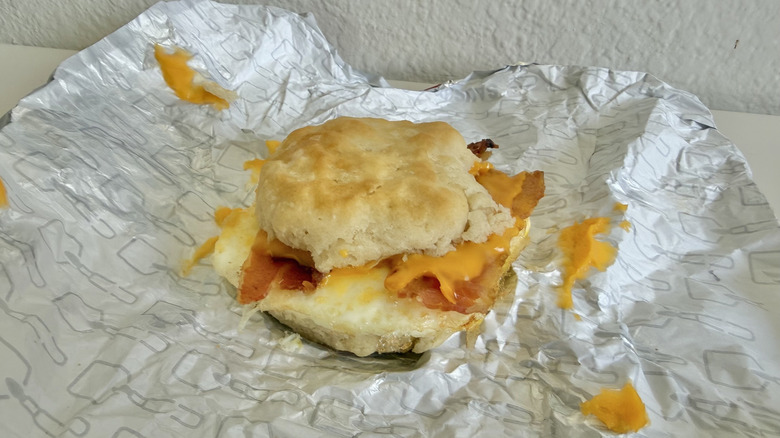 Bacon, Egg, & Cheese Biscuit with cheese on a wrapper