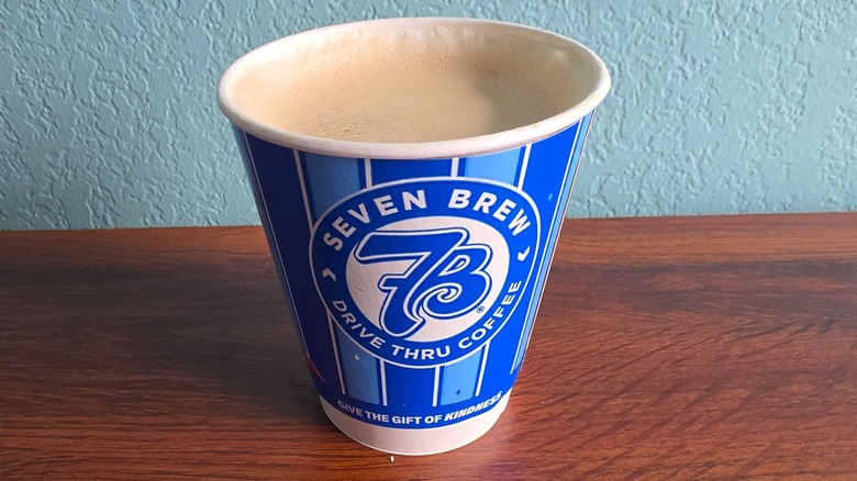 Cup of vanilla latte on table