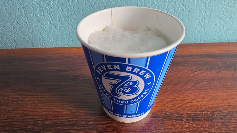 Cup of cupcake cappuccino on table