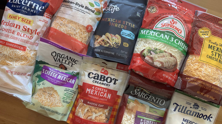 Bags of Mexican-style shredded cheese on wooden table