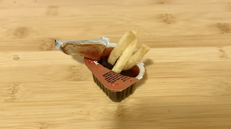 Popeye's BoldBQ sauce with french fries dipped in it