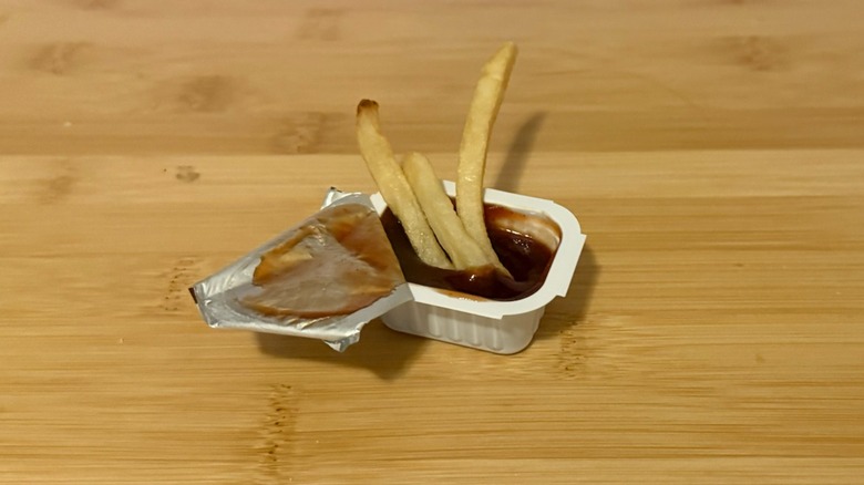 Burger King barbecue sauce packet with french fries dipped in it