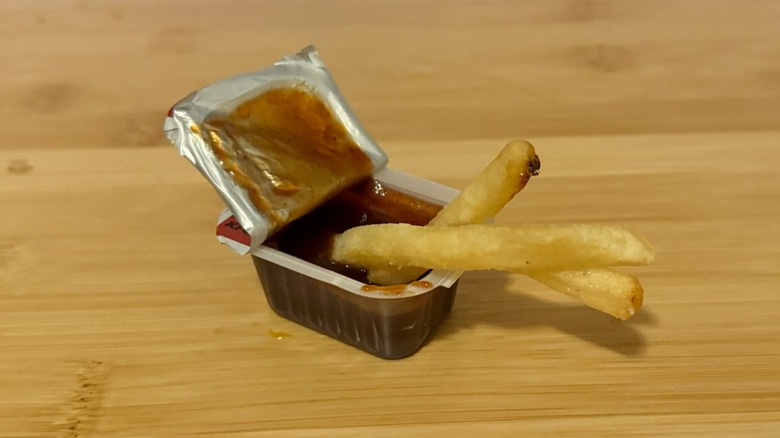 KFC barbecue Sauce with french fries dipped in it