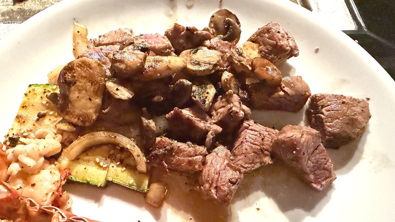 Close-up of Benihana filet mignon and veggies on white plate