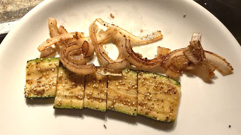 Close-up of Benihana hibachi vegetables, zucchini and onion, on table at restaurant