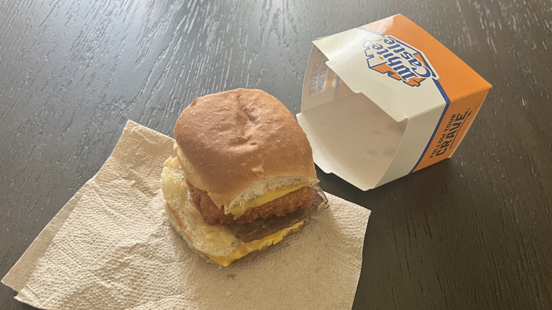 White Castle surf and turf slider outside the box on a dark table