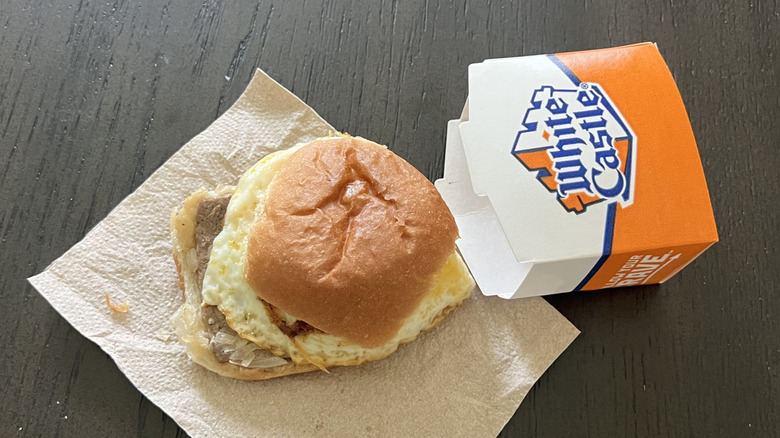 White Castle original breakfast slider placed on a napkin next to its box