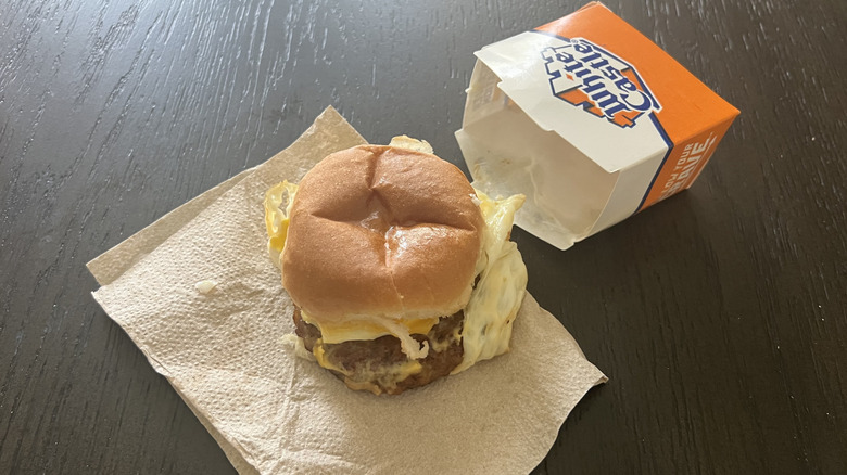 White Castle sausage breakfast slider with a to-go box next to it