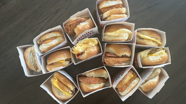 Top view of every White Castle slider in to-go boxes laid on a dark table