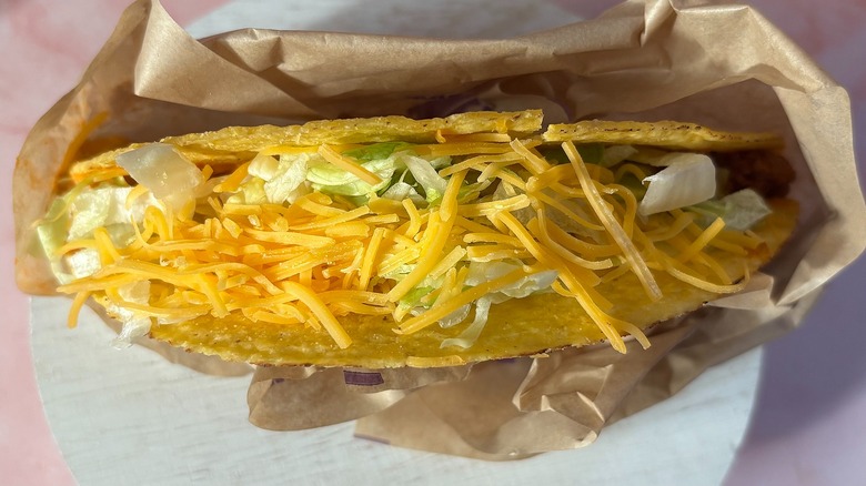 Close-up of Taco Bell Volcano Crunchy Taco on pink background