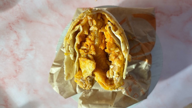 Close-up of Taco Bell Volcano Quesarito on pink background