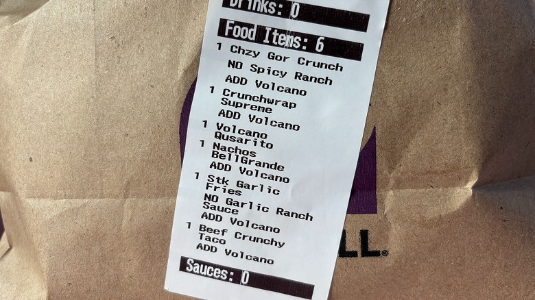 Close-up of receipt with menu items on side of Taco Bell bag