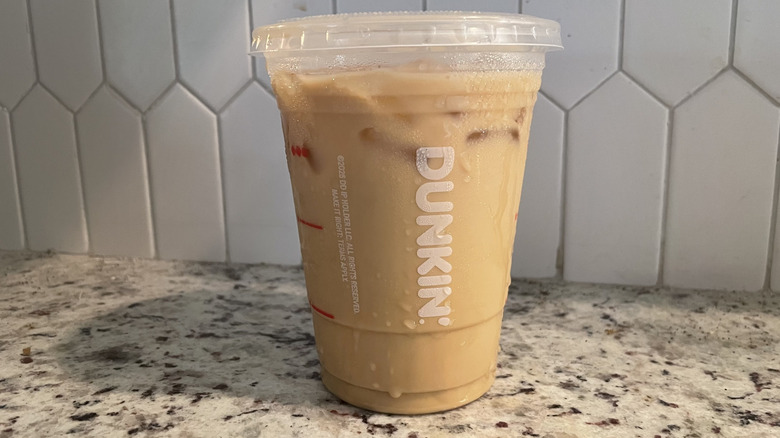 Dunkin Donuts iced latte on a granite countertop