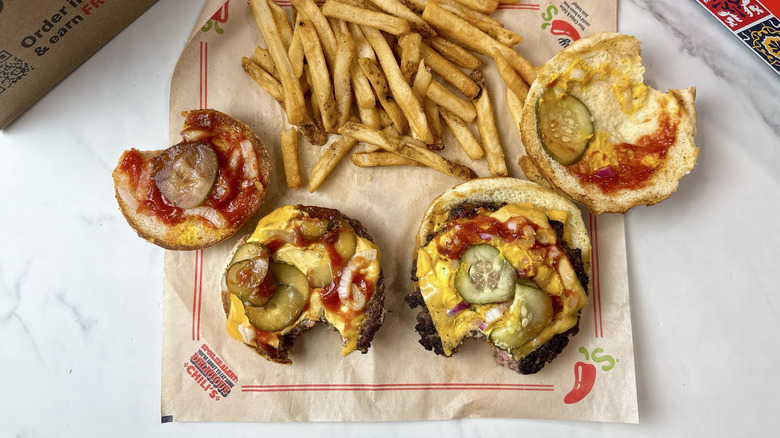 McDonald's Quarter Pounder with Cheese aside the Chili's Big QP burger with the buns flipped to reveal the toppings