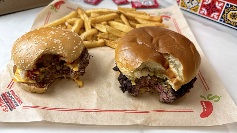 McDonald's Quarter Pounder with Cheese aside the Chili's Big QP burger on a brown parchment paper