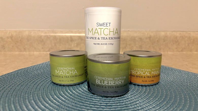 The Spice & Tea Exchange matcha offerings on a blue placemat and neutral background