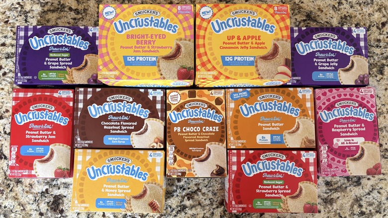 Uncrustables in boxes on marble countertop