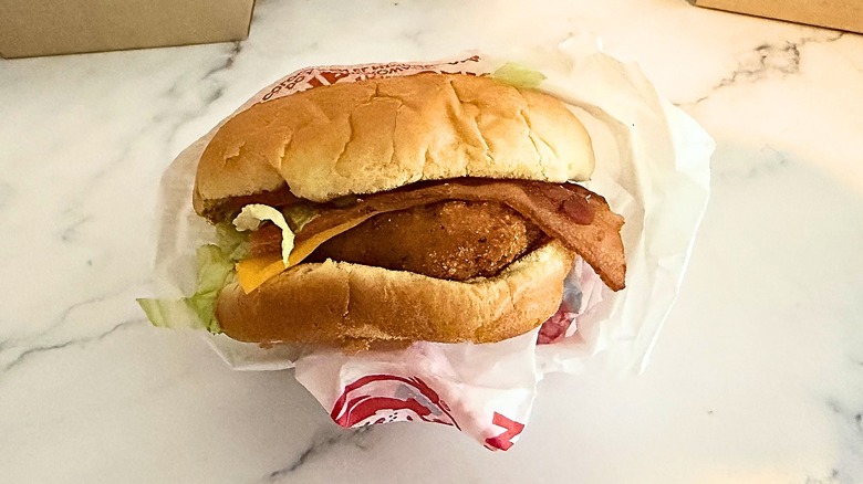 Wendy's Crispy Chicken BLT in wrapper on marble surface