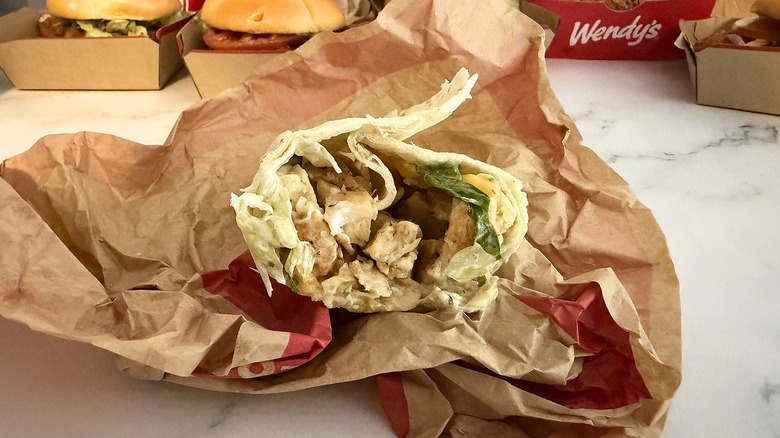 Wendy's Grilled Chicken Wrap in wrapper on marble surface
