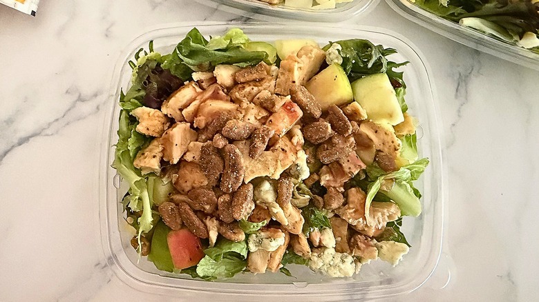 Wendy's Apple Pecan Salad in container on marble surface