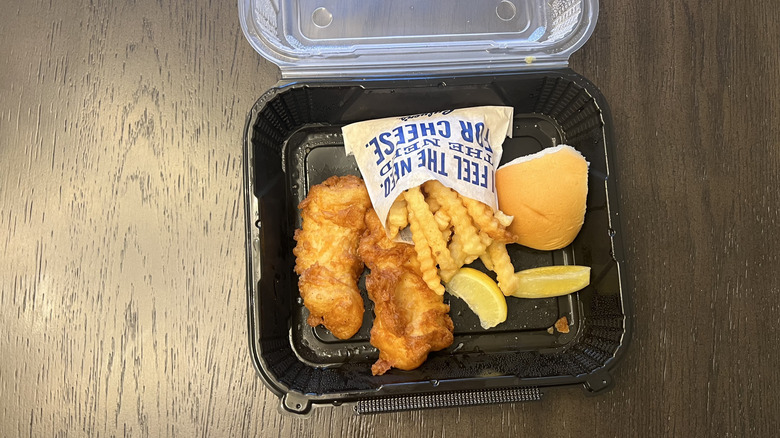 Culver's two piece North Atlantic Cod dinner in to-go box with lemon slices, fries, and a bread roll