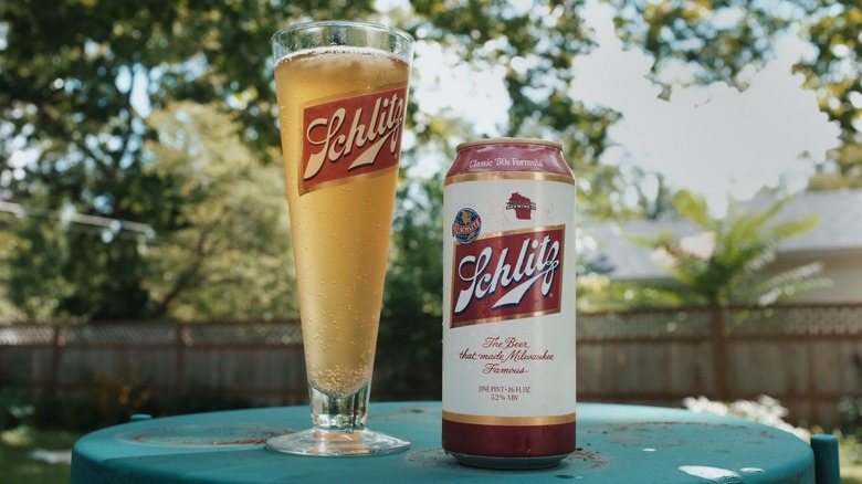 Can of limited-edition Schlitz alongside frosty vintage Schlitz glass