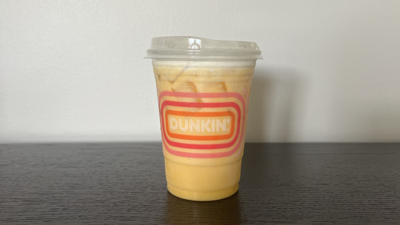 Dunkin' Mango Pineapple Daydream Refresher in a to-go cup.