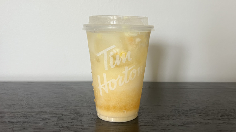 Tim Hortons Tropical Mango Coconut Refresher in a to-go cup.