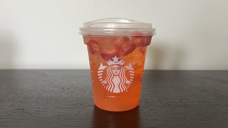 Starbucks Mango Strawberry Energy Refresher in a to-go cup.