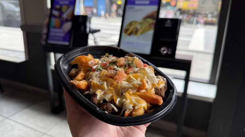 Diablo Ranch Steak Nacho Fries held in the air