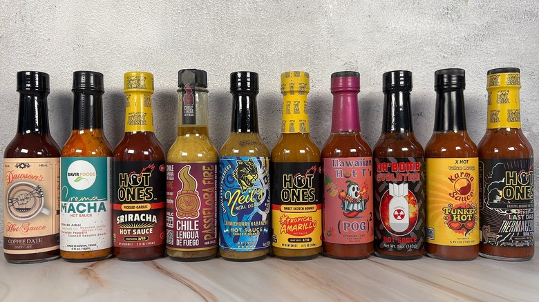 10 Hot Ones Hot Sauces lined up on table
