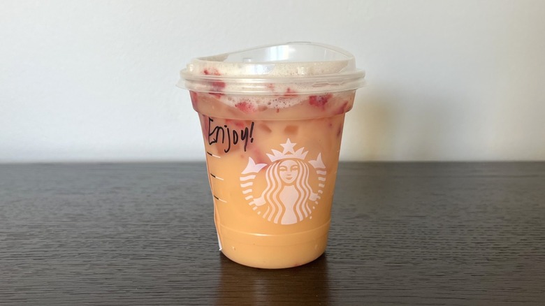 Starbucks Mango Dream Refresher in a to-go cup.