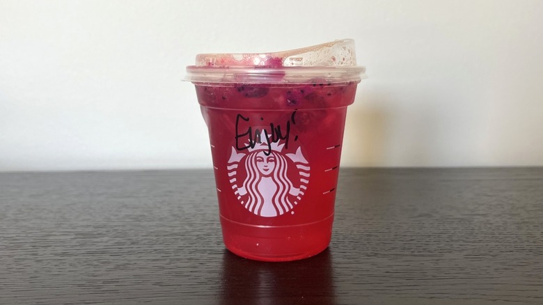 Starbucks Mango Strawberry Lemonade Refresher in a to-go cup.