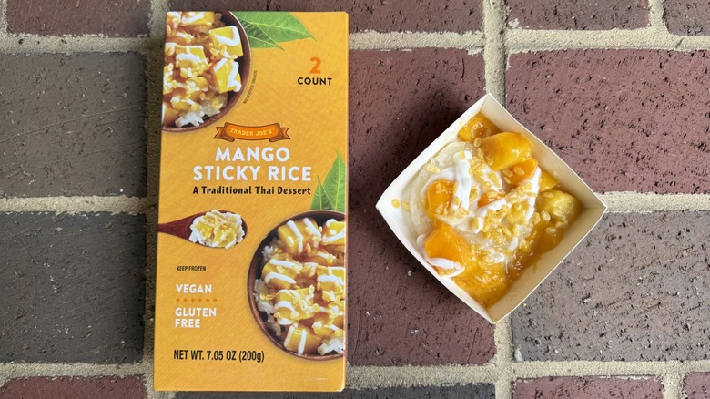Box of Trader Joe's mango sticky rice alongside freshly prepared portion on brick surface