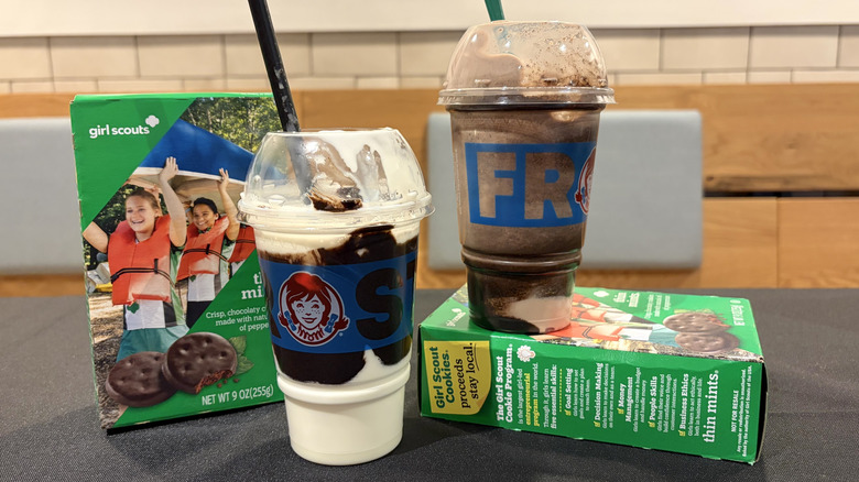Wendy's New Thin Mints Frosty Fusion and Thin Mints Frosty Swirl with boxes of Girl Scout cookies