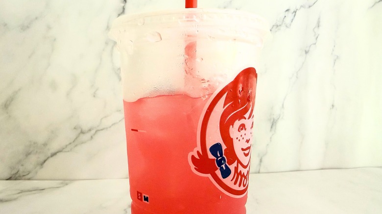 Side view of partially consumed Wendy's watermelon lemonade