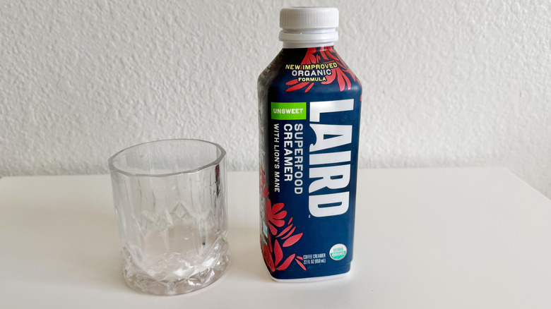 Laird unsweetened creamer next to glass
