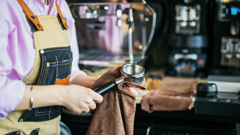 Barista cleaning an espresso machine