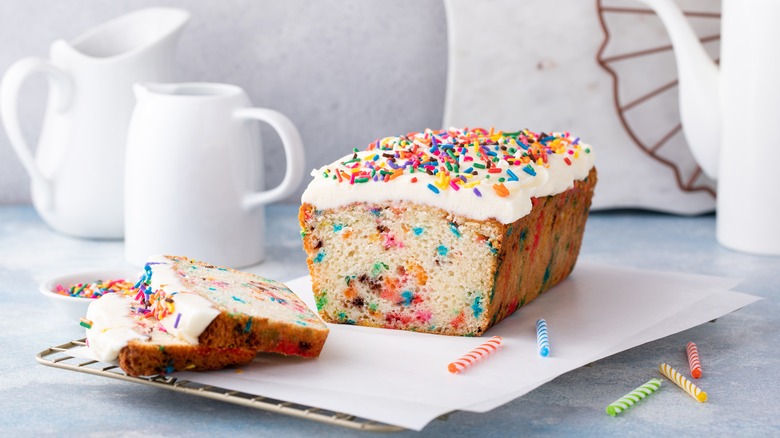 Frosted pound cake covered with and baked with sprinkles inside