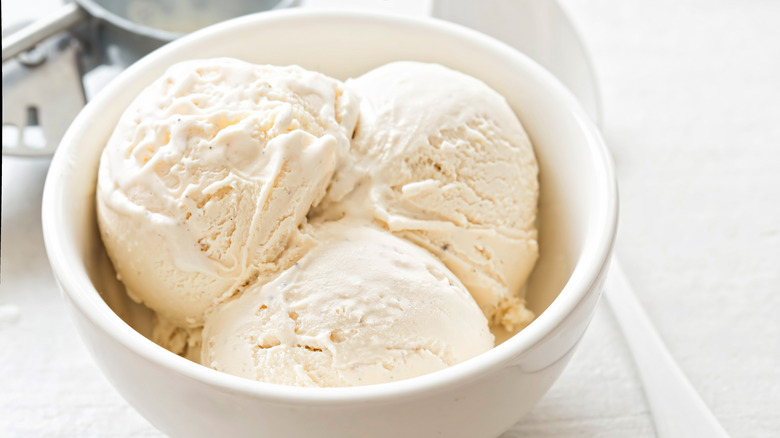 Vanilla ice cream scoops in a white bowl