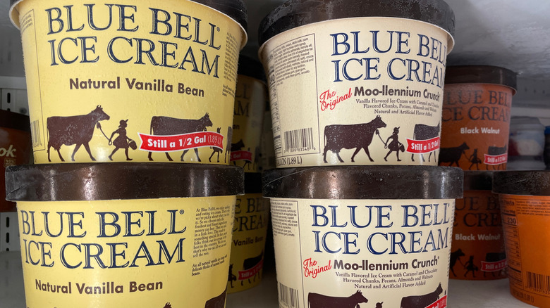 Tubs of Blue Bell ice cream in a freezer at a store