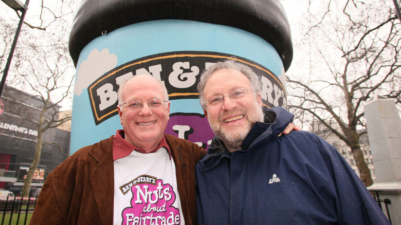 Ben Cohen and Jerry Greenfield in front of a Ben and Jerry's sign