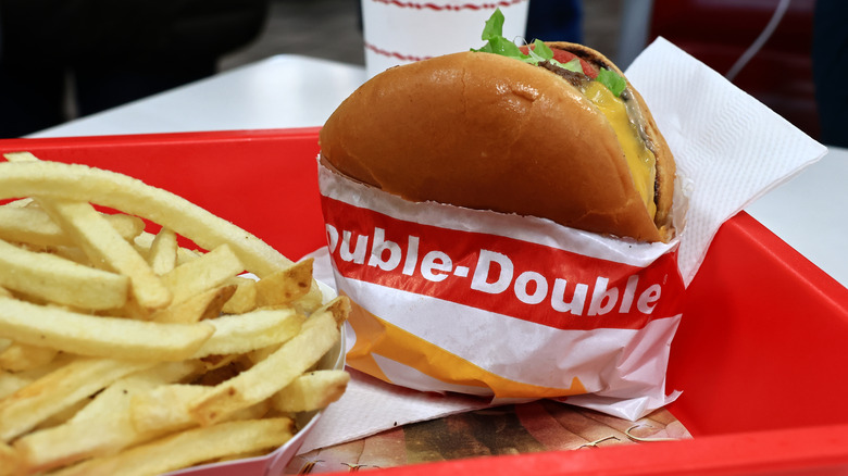 In-N-Out Double-Double in paper next to fries