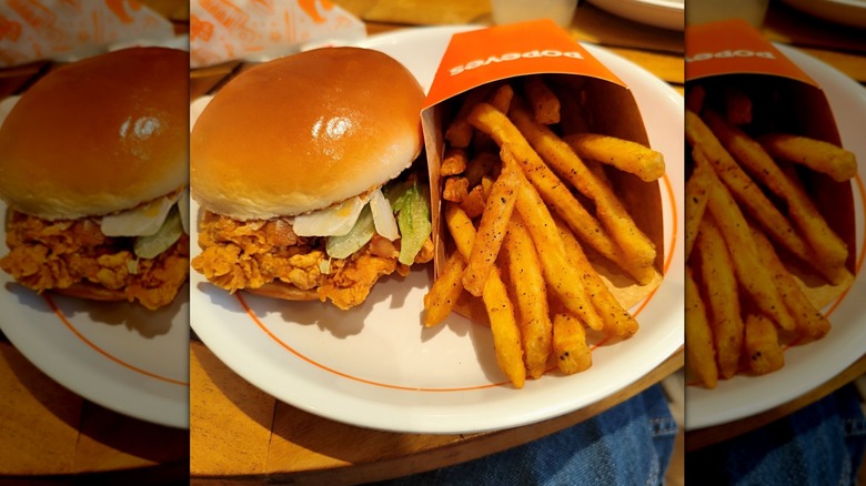 Popeyes Spicy Chicken Sandwich with fries on white plate