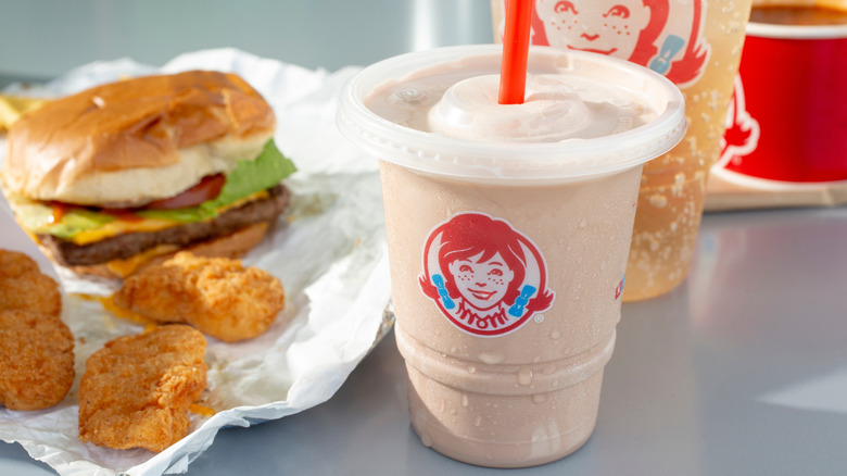 Wendy's Frosty with burger and chicken nuggets in background