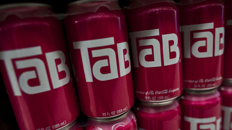 A stack of TaB soda cans, held together with plastic rings.