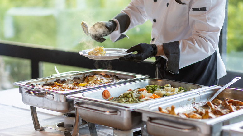 staff serving food from buffet