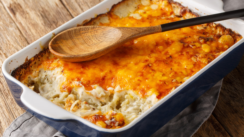 a loaded baked potato casserole on a wood table