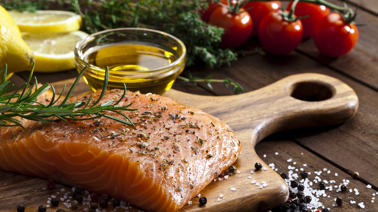 Salmon cutting board herbs olive oil 