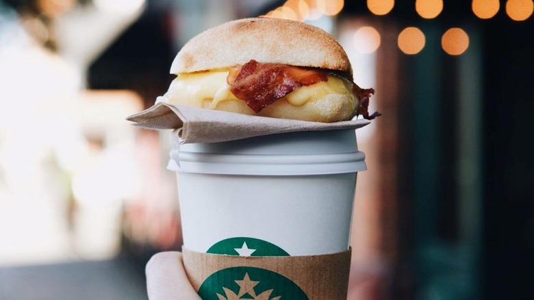 A Starbucks Bacon, Gouda, and Egg Sandwich on a coffee cup